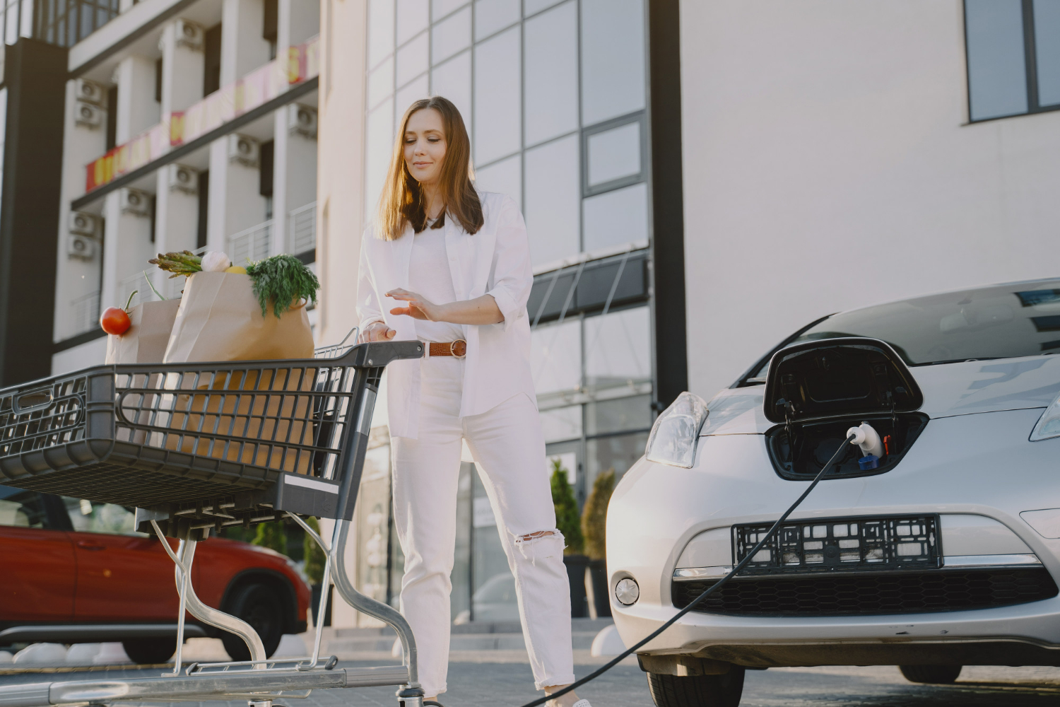 Modern EV charging with CITA wallbox as woman plugs in her electric car.
