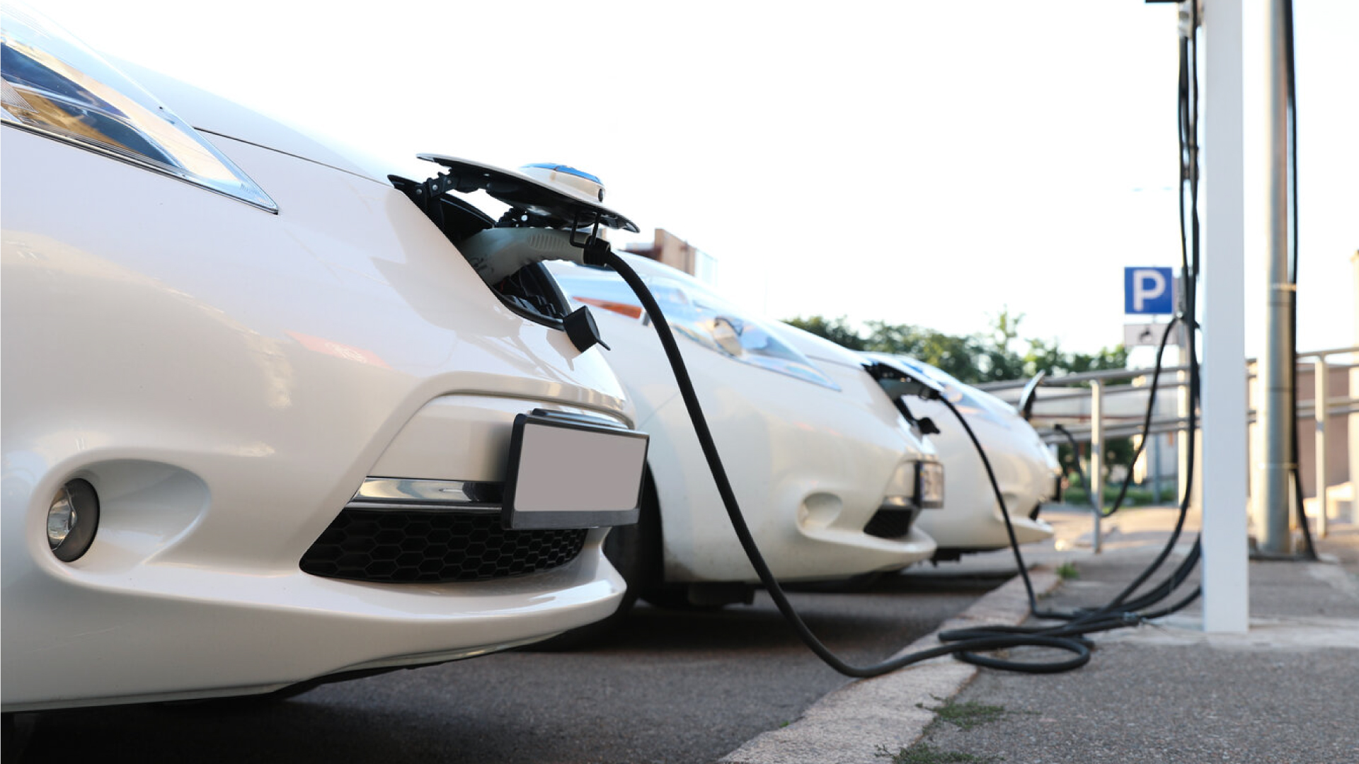 User charging white electric vehicle with a CITA EV charger.